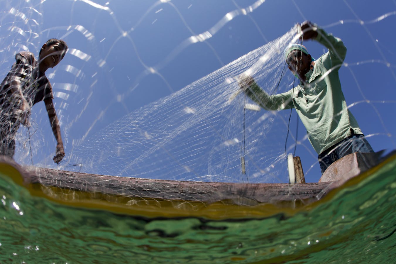Fisherman cast a net to catch fish 