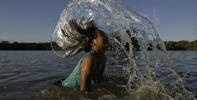 Macushi girl playing in water 