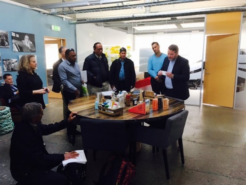Nainoa Thompson (kneeling), together with participants of CI’s Iceland-Pacific fisheries exchange, learn about value-added products extracted from fish, at the Sjávarklasinn Ocean Cluster House in Reykjavik, Iceland.